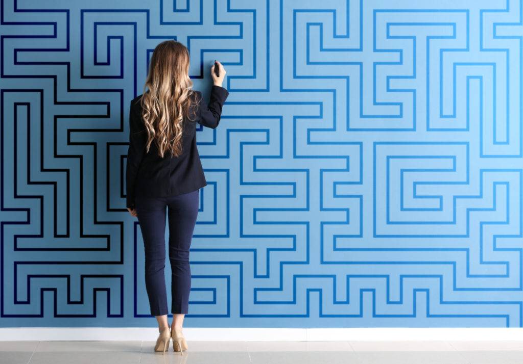 Business woman working on solving a maze